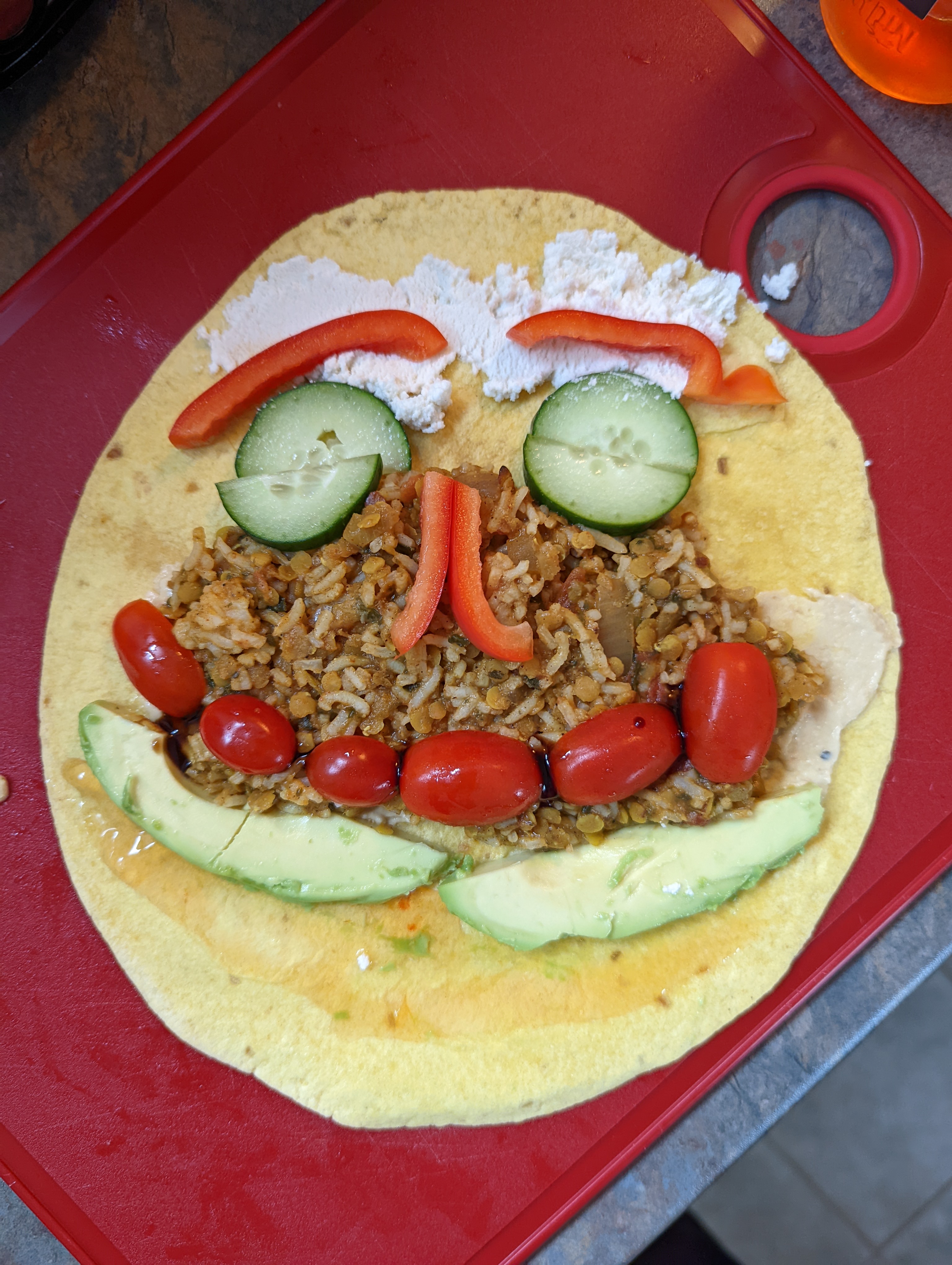 the contents of a wrap arranged in the shape of a smiley face.